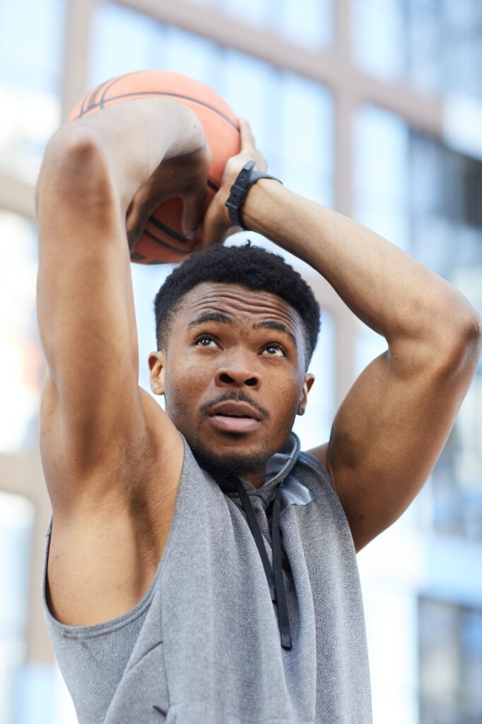 Muscular African-American Man Throwing Basketball Ball